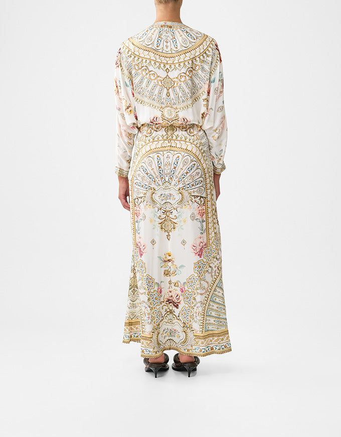 Person wearing a long, ornate dress with intricate patterns on a white background. Ottoman Dynasty Twist Front Batwing Dress