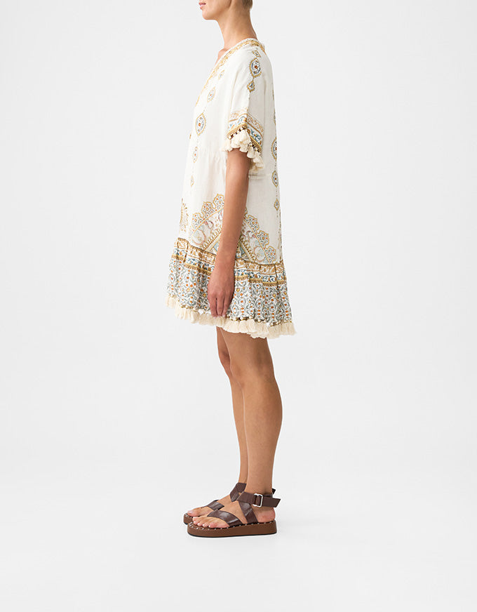 Woman wearing a white dress with floral patterns on a plain background. Ottoman Dynasty Short V Neck Embroidered Dress