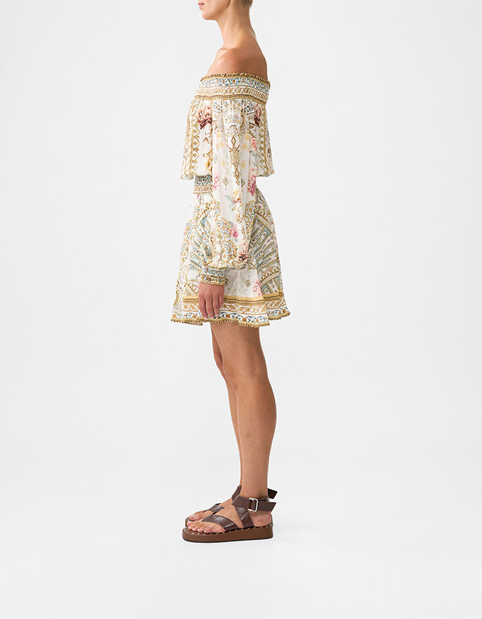 Woman wearing a floral off-shoulder dress on a white background. Ottoman Dynasty Off The Shoulder Short Dress