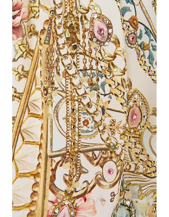 close up of ornate gold print on cream silk fabric. Ottoman Dynasty Off The Shoulder Short Dress
