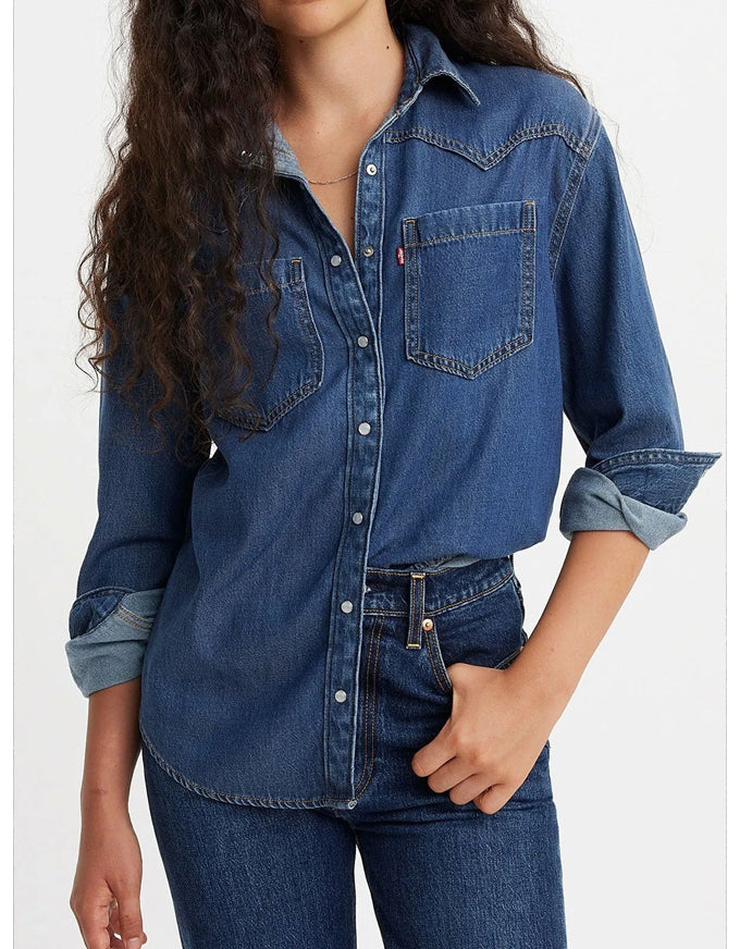 Person wearing a blue denim shirt and jeans on a white background. Teodora Western Shirt Air Space