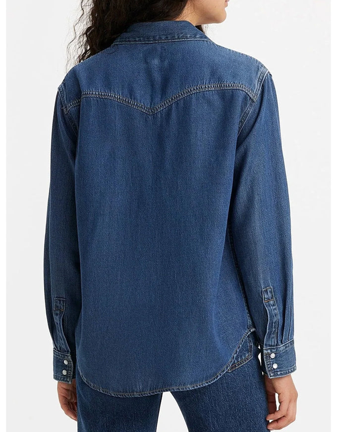 Blue denim shirt worn by a person on a white background. Teodora Western Shirt Air Space