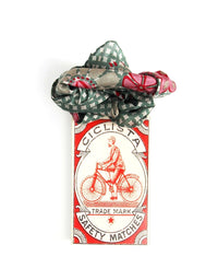 Ciclista safety matches packaging with a decorative bow on a white background