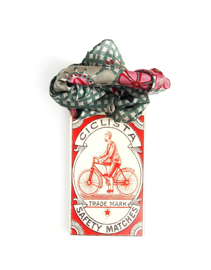 Ciclista safety matches packaging with a decorative bow on a white background