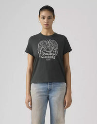 Person wearing a black t-shirt with a graphic design and text, standing against a plain background