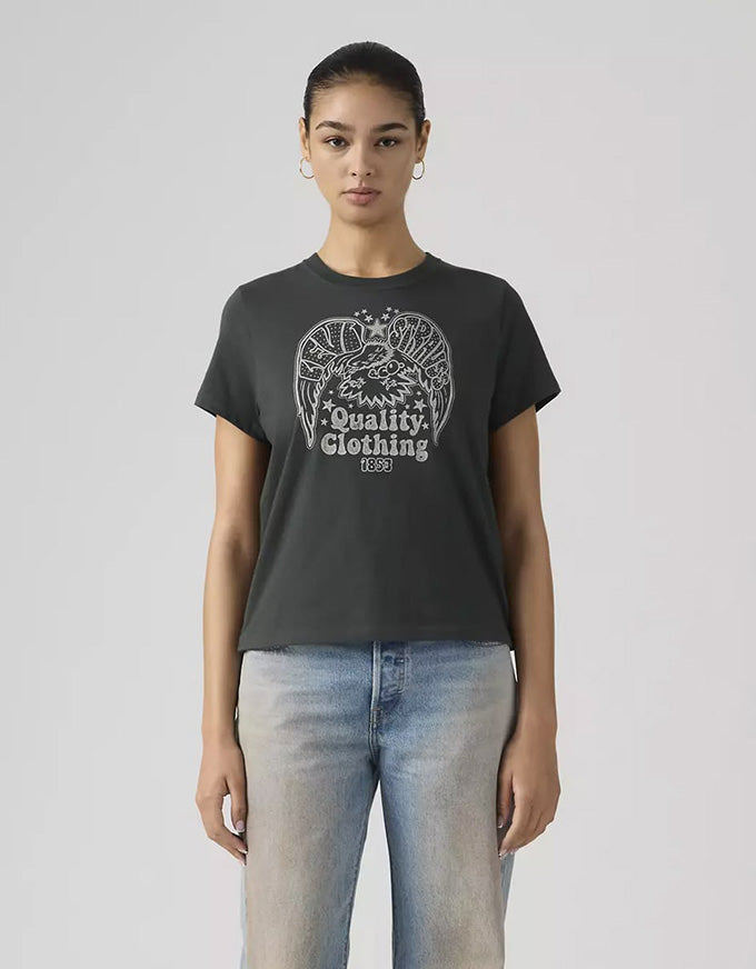 Person wearing a black t-shirt with a graphic design and text, standing against a plain background