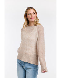 Woman wearing a beige sweater and blue jeans on a white background