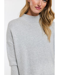 Woman wearing a gray sweater on a white background