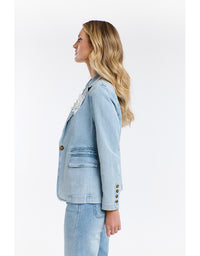 Woman wearing a light blue denim jacket on a white background