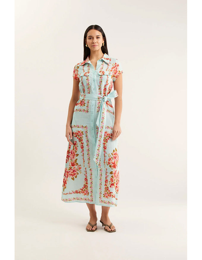 Woman wearing a floral linen dress on a white background