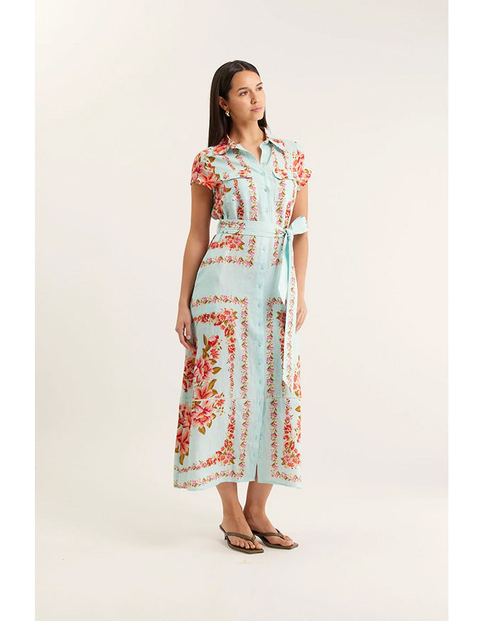 Woman wearing a floral dress on a plain background