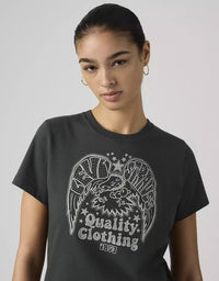 Person wearing a black t-shirt with a graphic design and text on a plain background
