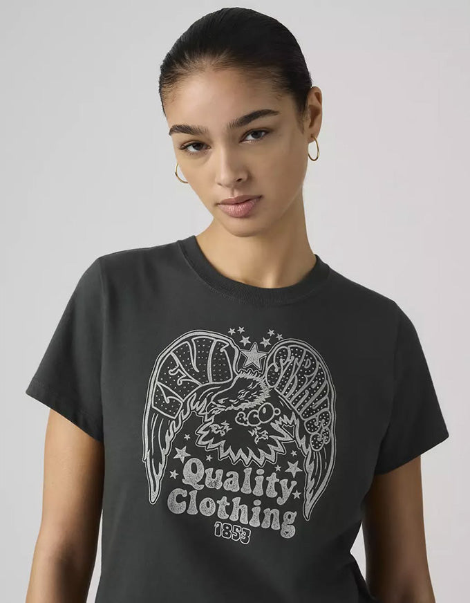 Person wearing a black t-shirt with a graphic design and text on a plain background