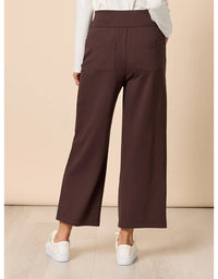 Brown wide-leg pants worn by a person on a beige background