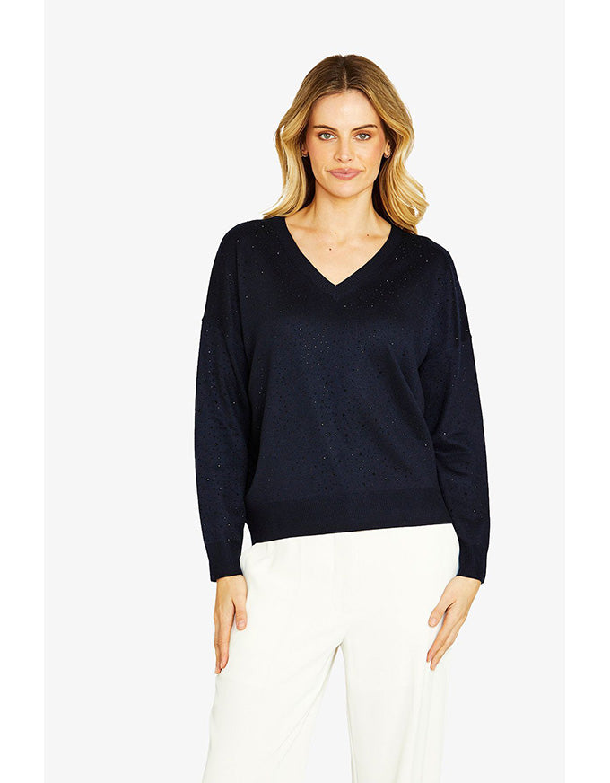 Woman wearing a navy blue sweater on a white background