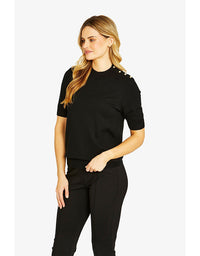 Woman wearing a black outfit with decorative elements on a white background
