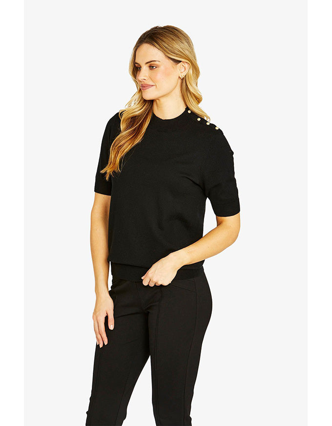 Woman wearing a black outfit with decorative elements on a white background