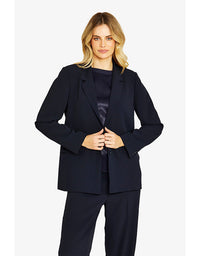Woman wearing a navy suit on a white background