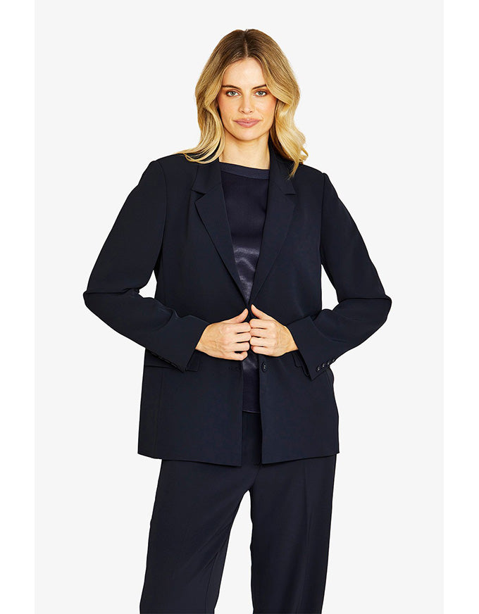 Woman wearing a navy suit on a white background