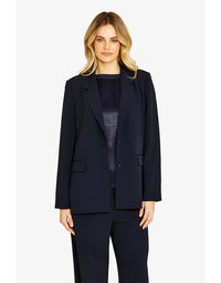 Woman wearing a navy suit on a white background