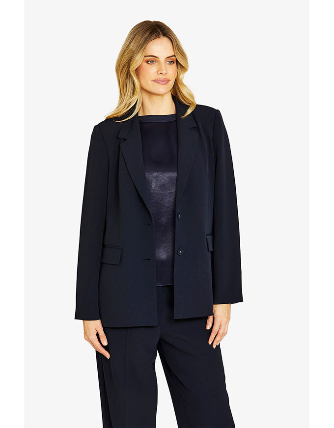 Woman wearing a navy suit on a white background