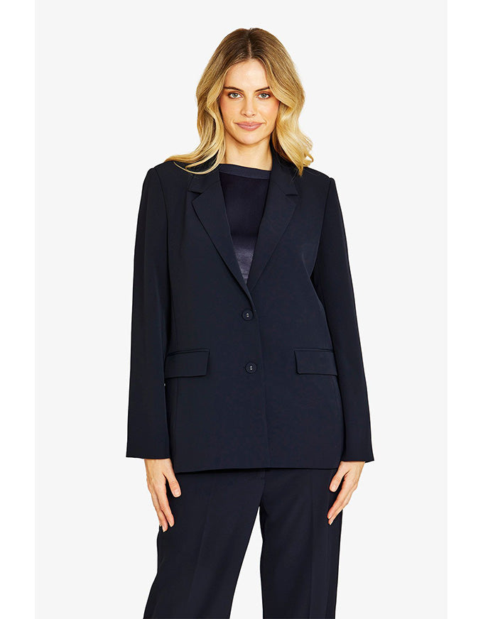 Woman wearing a navy suit on a white background