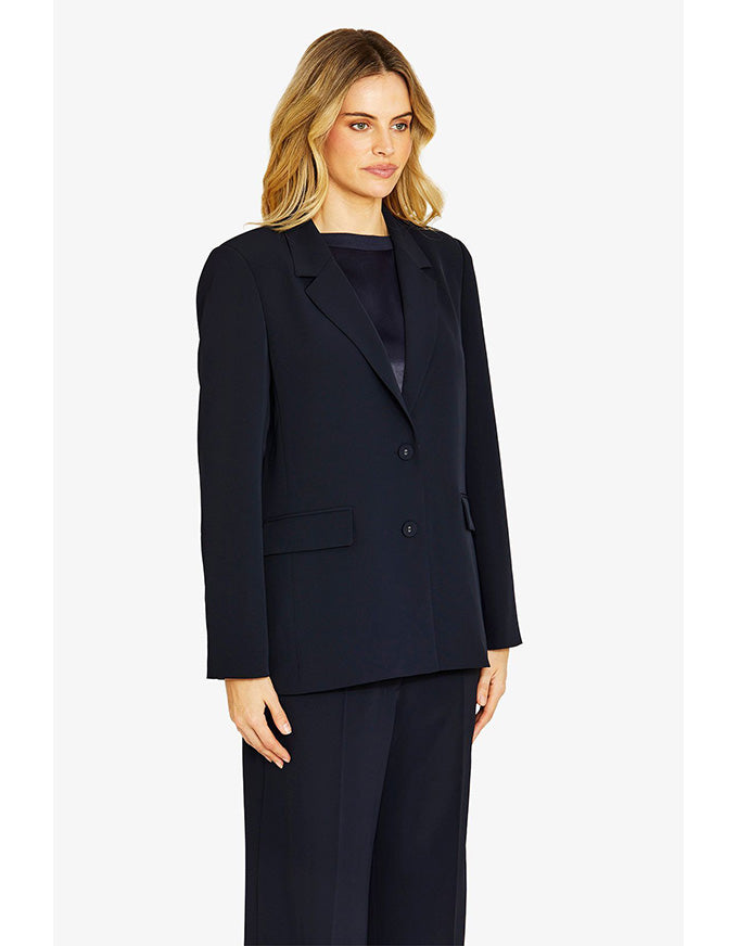 Woman wearing a navy suit on a white background