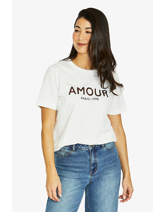French short sleeve tee in ivory with ‘Amour Paris 1998’ chestnut print and crew neckline, worn on model