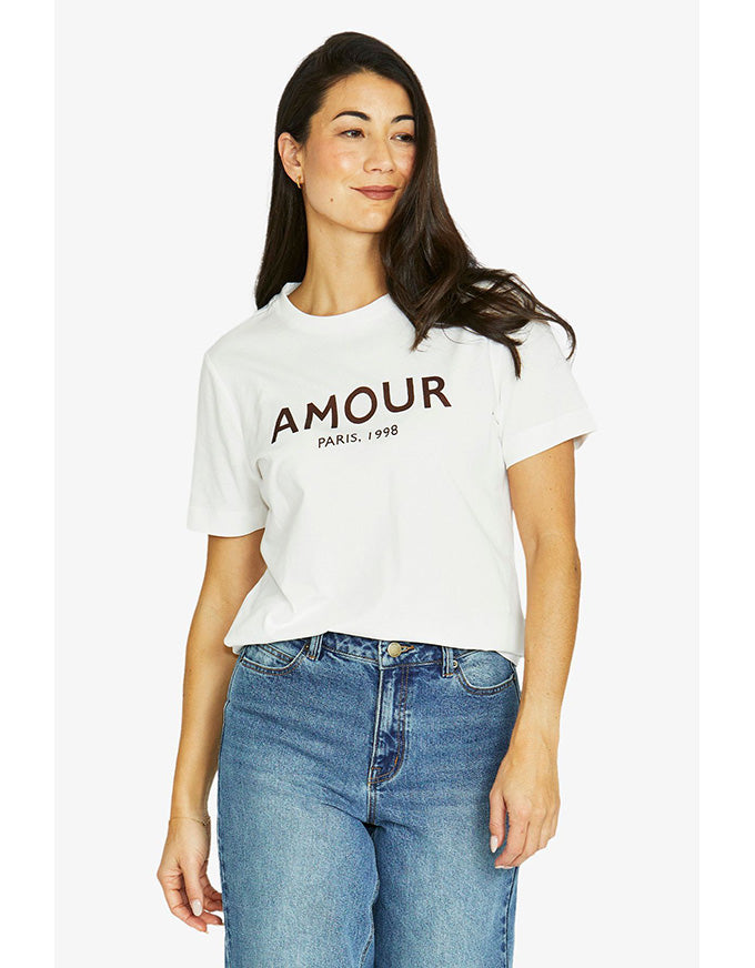 French short sleeve tee in ivory with ‘Amour Paris 1998’ chestnut print and crew neckline, worn on model