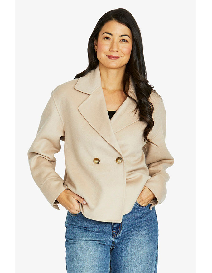 Crop coat in stone with double-breasted front, wide lapel collar and cropped length