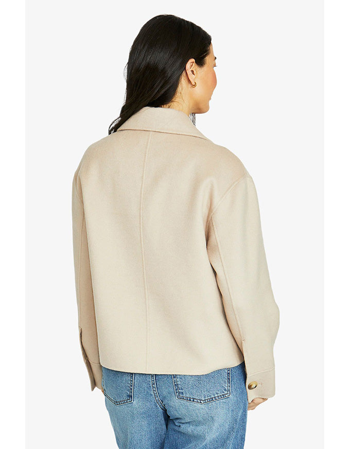 Crop coat in stone with double-breasted front, wide lapel collar and cropped length