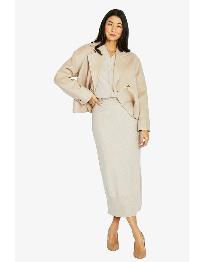 Crop coat in stone with double-breasted front, wide lapel collar and cropped length