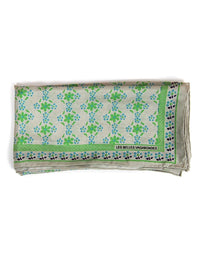Folded fabric with green floral pattern on a white background
