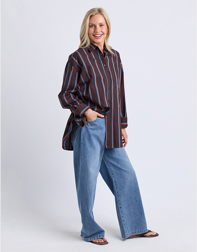 Woman wearing a striped shirt and jeans on a white background