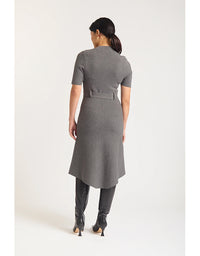 Woman wearing a gray dress with a belt on a white background