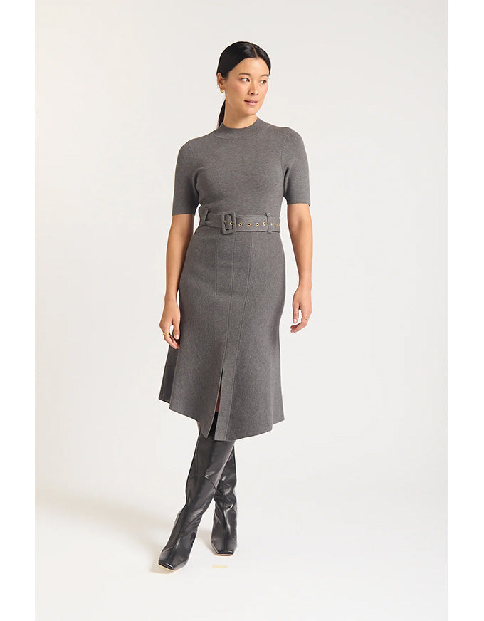 Woman wearing a gray dress with a belt on a white background