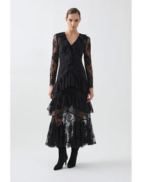 Black lace dress worn by a model on a white background