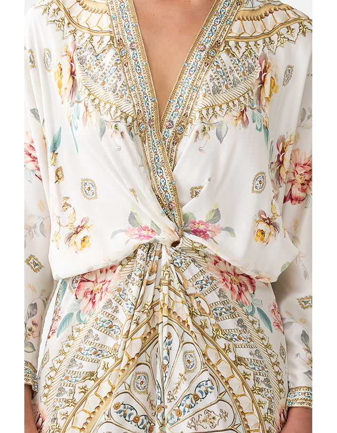 Floral and paisley patterned dress with a tie waist on a white background. Ottoman Dynasty Twist Front Batwing Dress