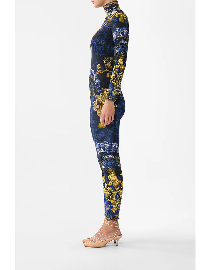 Navy blue jumpsuit with gold floral pattern on a white background