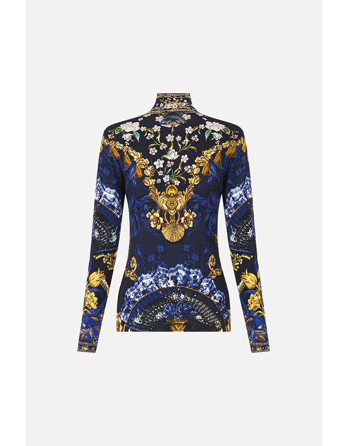 Long-sleeve top with intricate floral and baroque design on a white background