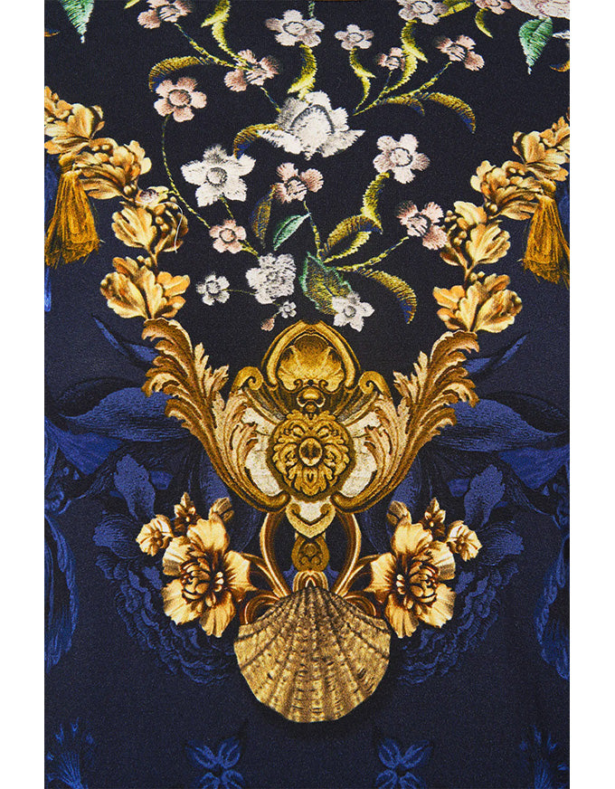 Decorative fabric with floral and shell pattern on a dark blue background