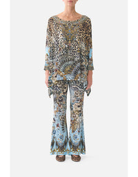 Person wearing a patterned outfit on a white background