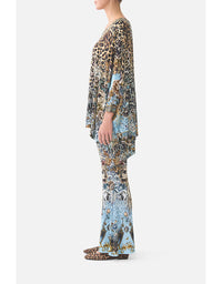 Person wearing a patterned outfit on a white background