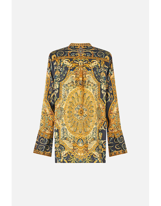 Long-sleeve top with intricate gold and black pattern on a white background