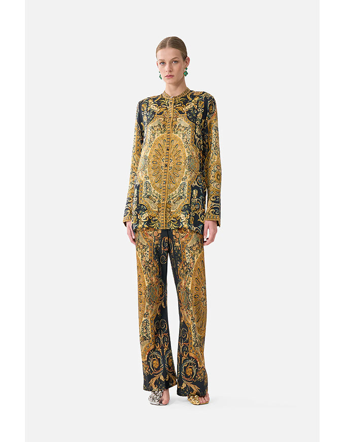 Model wearing a patterned outfit on a white background