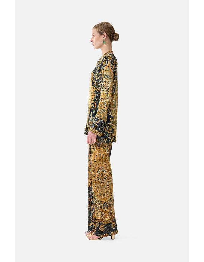Woman wearing a patterned outfit on a white background