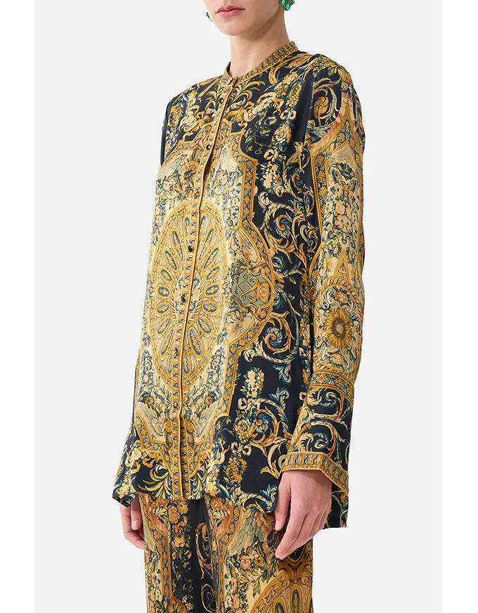 Long-sleeve shirt with intricate gold and black pattern on a white background