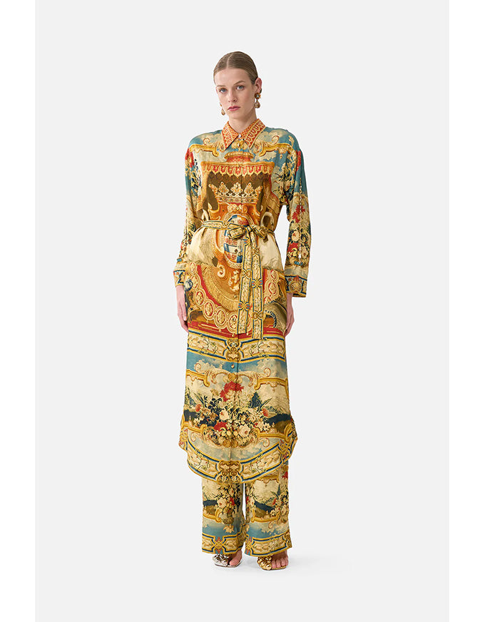 Woman wearing a colorful patterned outfit on a white background