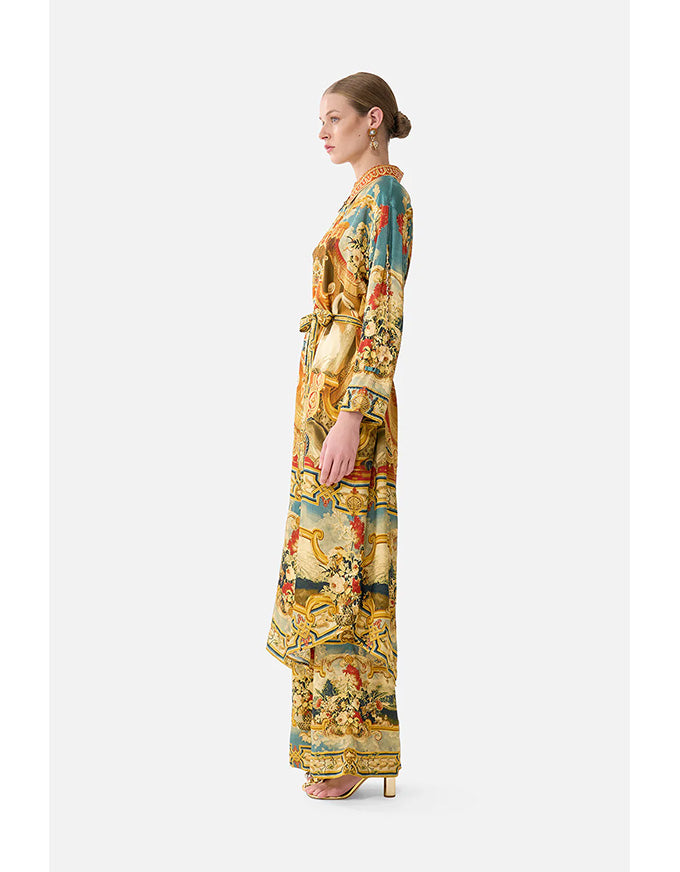 Woman wearing a colorful floral dress on a white background
