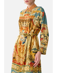 Colorful patterned dress with a belt on a white background